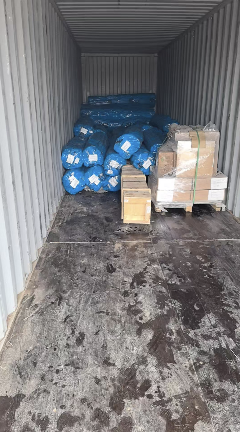 Blue-wrapped MVAC materials loaded in a container for the Kandinma Holdings Phase 2 project
