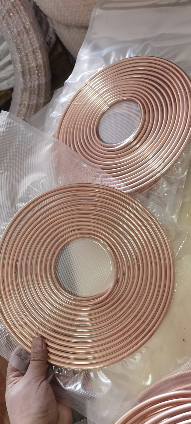 Soft copper tube coils wrapped in clear plastic film for shipment