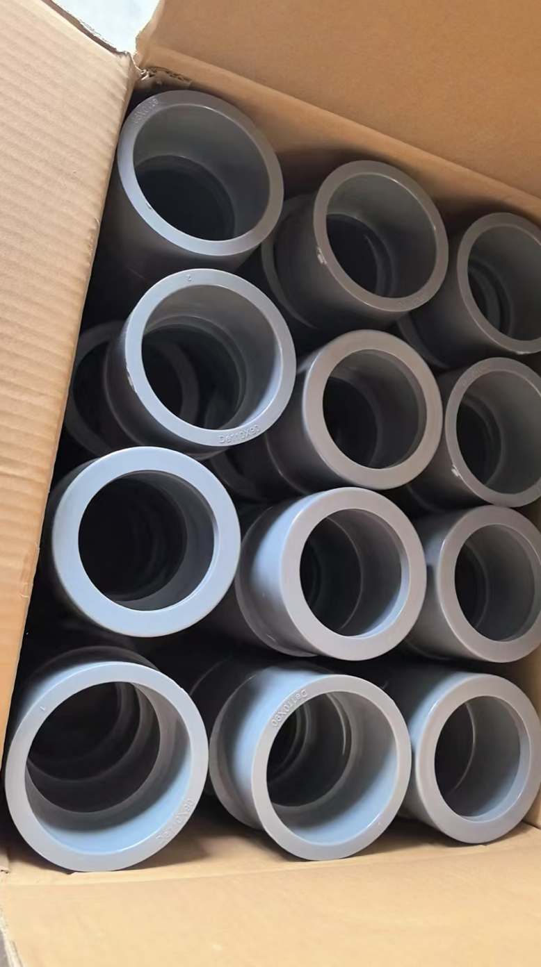 Grey uPVC reducer bushes packed in a cardboard carton