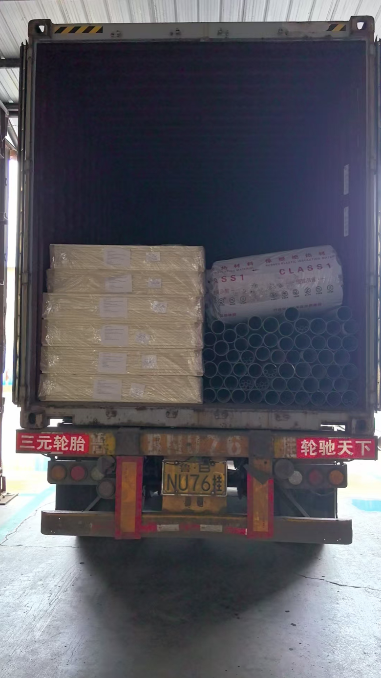 Loaded container with wrapped sheet stacks, insulation and pipe ends